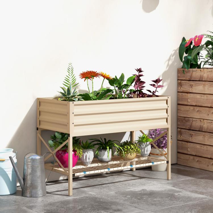 Cream metal raised garden bed on legs with lower shelf and potted plants on patio