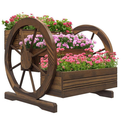 Wooden wagon-style planter box with three tiers and two front wheels, with pink flowers