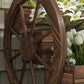 Wooden wagon planter box with arched frame, large wheels, and dark wood interior