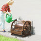 Wooden wagon-style planter box with wheels, shown on grass with flowers inside
