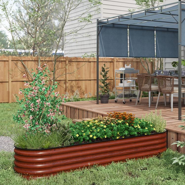 Brown raised planter bed with ribbed metal sides and mixed flowers and herbs