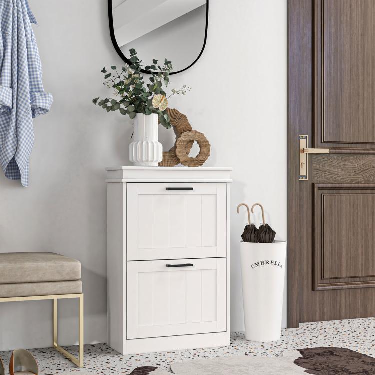 White two-drawer shoe storage cabinet with panel doors and black handles