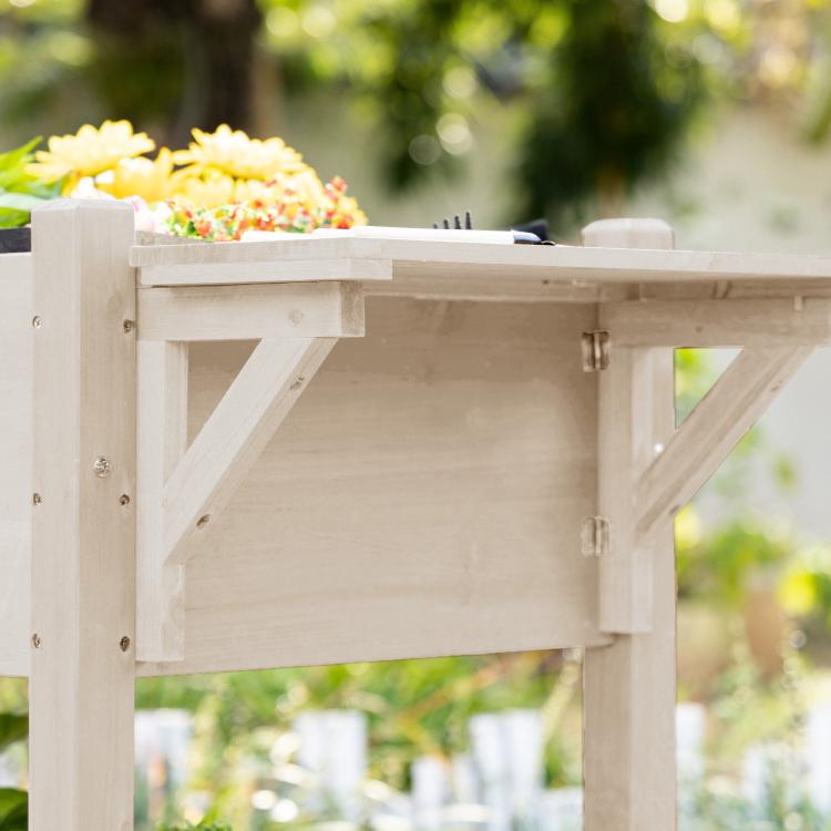 Under-shelf view of light wood raised garden planter box with support beams