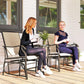 Patio rocking glider chairs with light beige sling fabric and dark armrests, small side table between