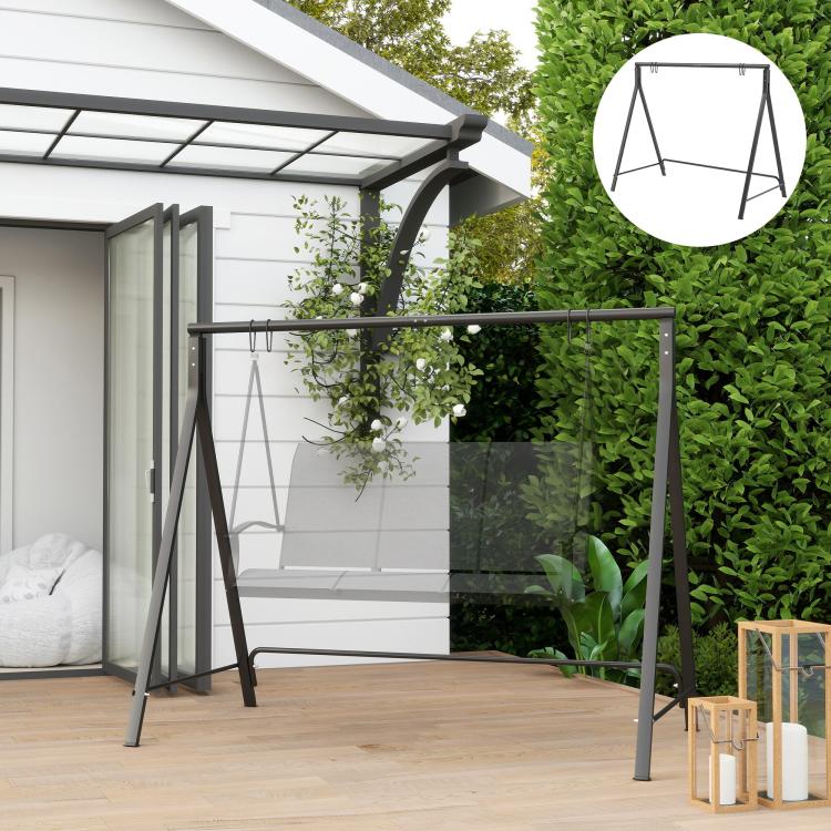 Black metal swing stand with top bar and hanging chains on a patio
