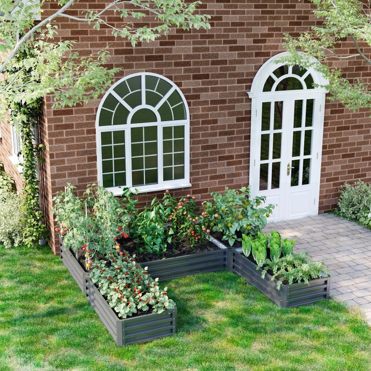 Gray steel raised garden bed set in backyard lawn, multiple long planters filled with plants
