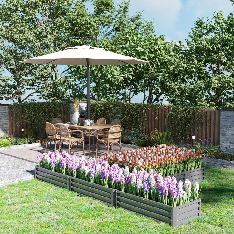 Gray steel raised garden bed set outdoors with rows of purple and orange flowers