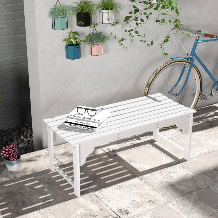 White slatted wooden garden bench with curved seat front, styled outdoors with decor