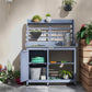 Gray potting bench with open cabinet shelves and gardening tool tabletop