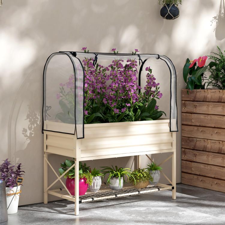 Cream metal raised garden bed with clear cover and bottom shelf for plants