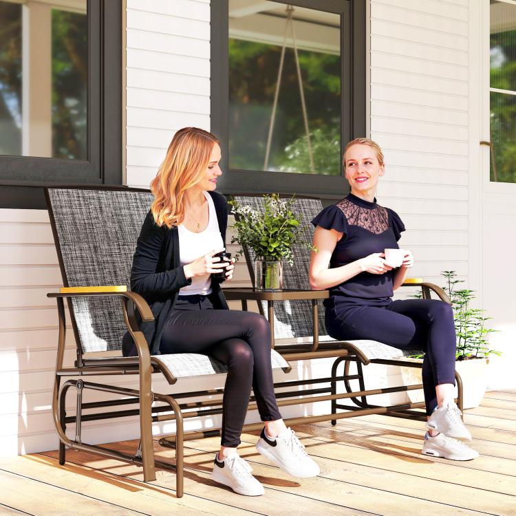 Gray outdoor glider bench with mesh backrests, armrests, and middle table