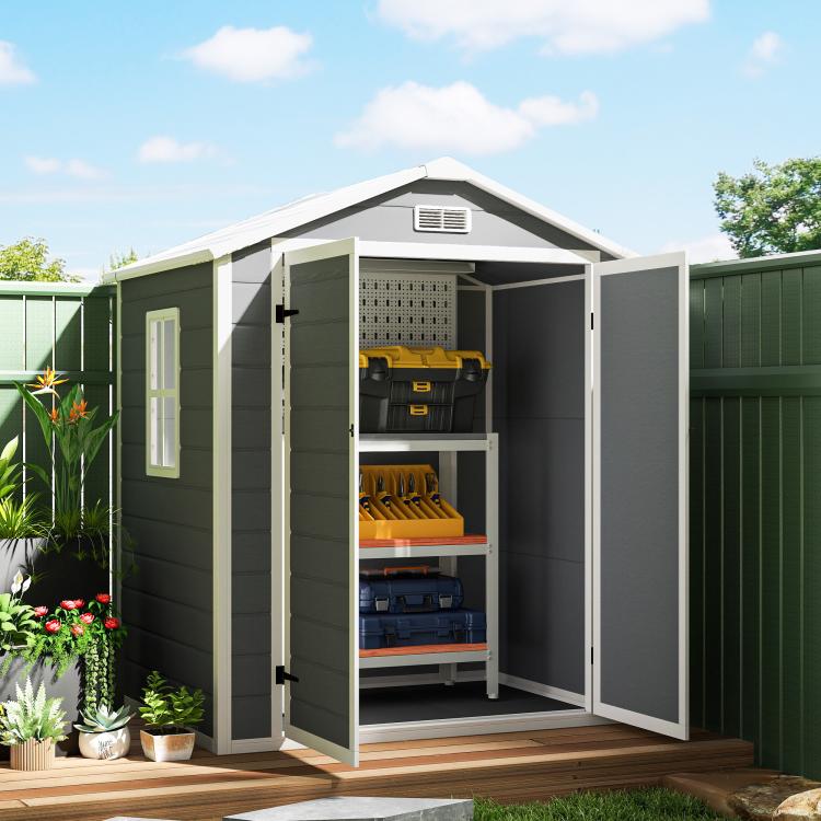 Gray plastic storage shed with double doors open, vented roof and shelves inside