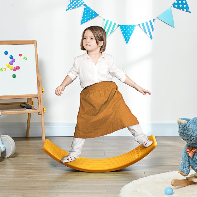 Orange balance board used by a child standing and wobbling during play