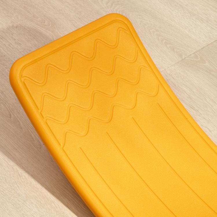 Orange balance board with raised textured pattern on the curved surface