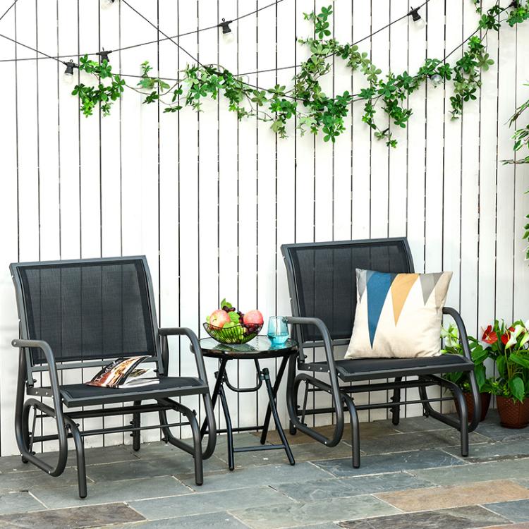 Two outdoor rocking glider chairs with gray mesh upholstery and black frames in patio set