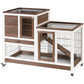 Brown wooden small animal hutch with enclosed run, wire doors, and caster wheels