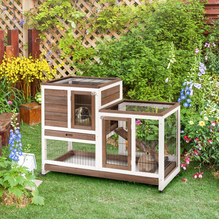 Outdoor wooden rabbit hutch with wire enclosure, ramp, and raised top platform on wheels