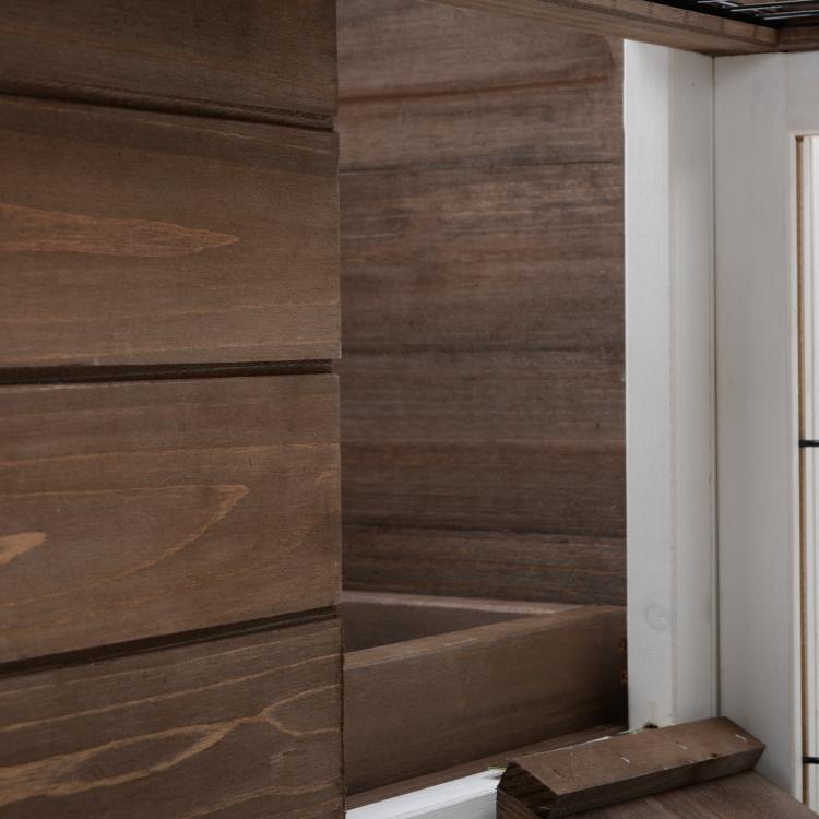 Close-up of wooden interior wall panel and ramp step in a rabbit hutch