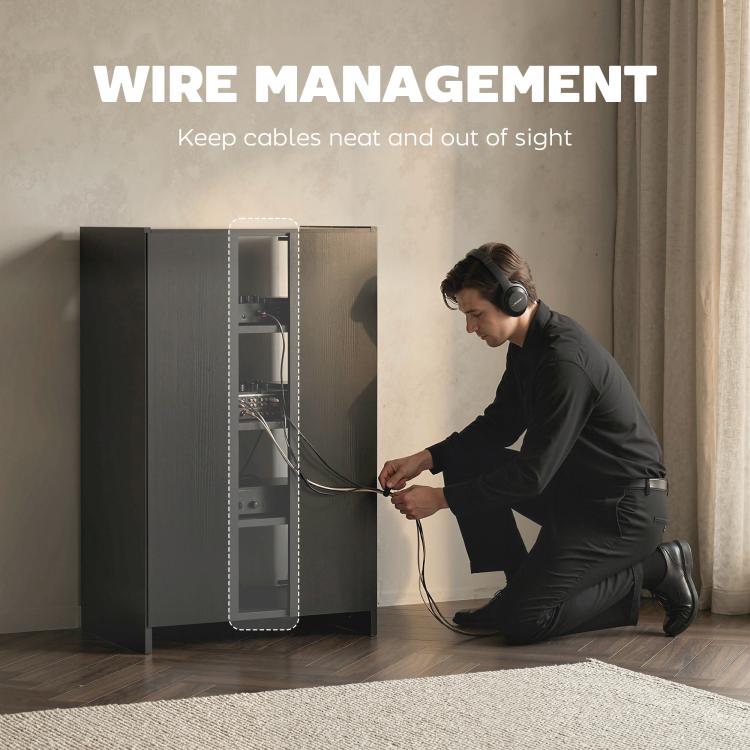 Dark media cabinet with cable management opening behind glass door