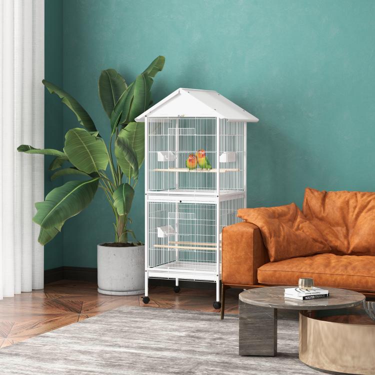White bird cage on rolling stand with perches and integrated feeder cups
