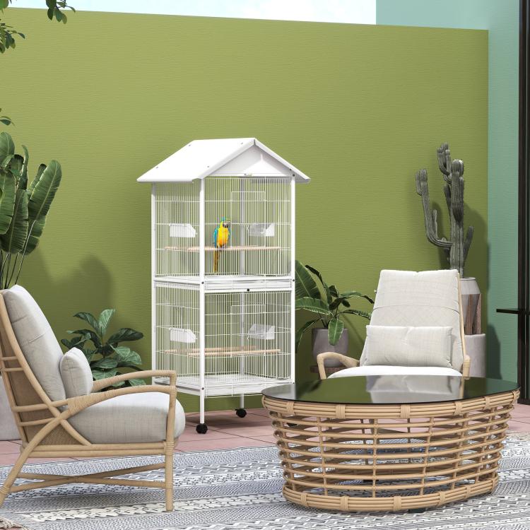 White wrought metal bird cage with stand, front doors, and rolling casters