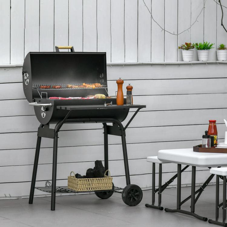Charcoal barbecue grill with open lid, side shelf, and lower shelf under firebox