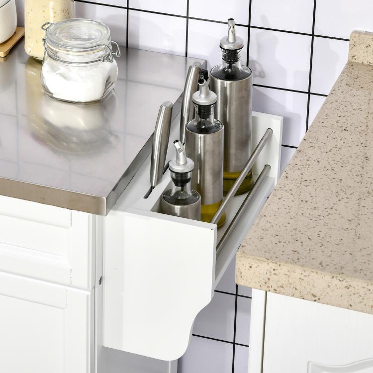 Stainless countertop side rack with spice containers beside a utensil holder on white cart
