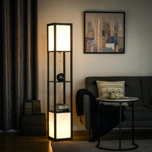 Black tall shelf floor lamp with glowing upper and lower panels beside a sofa