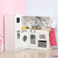 White corner kids play kitchen set with range hood, cooktop, sink faucet, and hanging apron