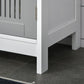 White pedestal cabinet corner with raised feet and open base space