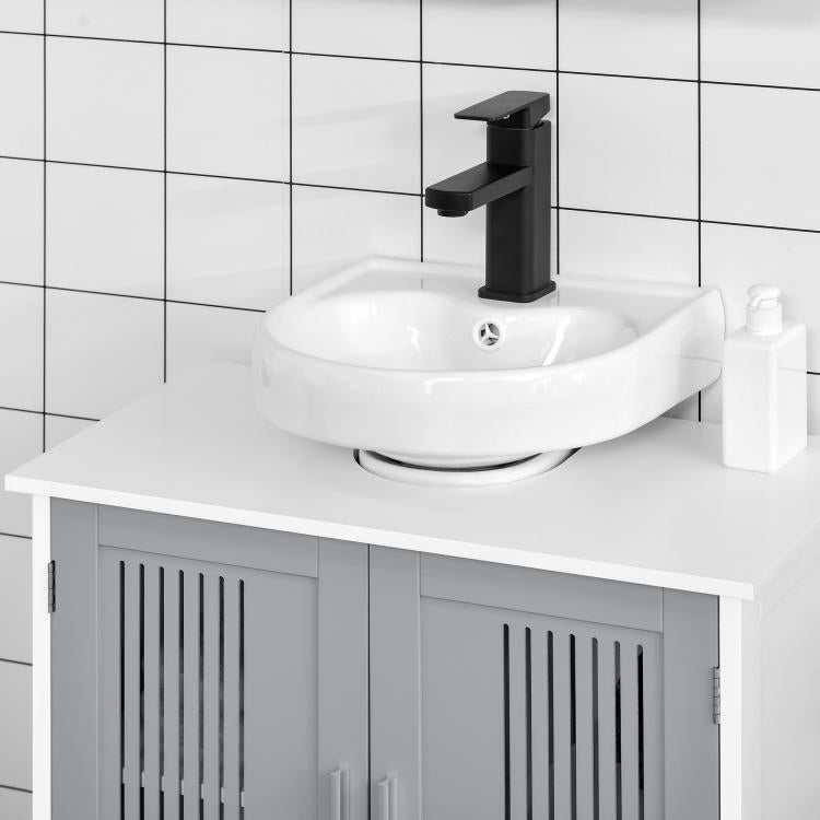 White bathroom vanity with grey slatted doors, sink, and faucet