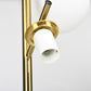 Gold 3-light globe floor lamp, close-up of round shades and brass stems