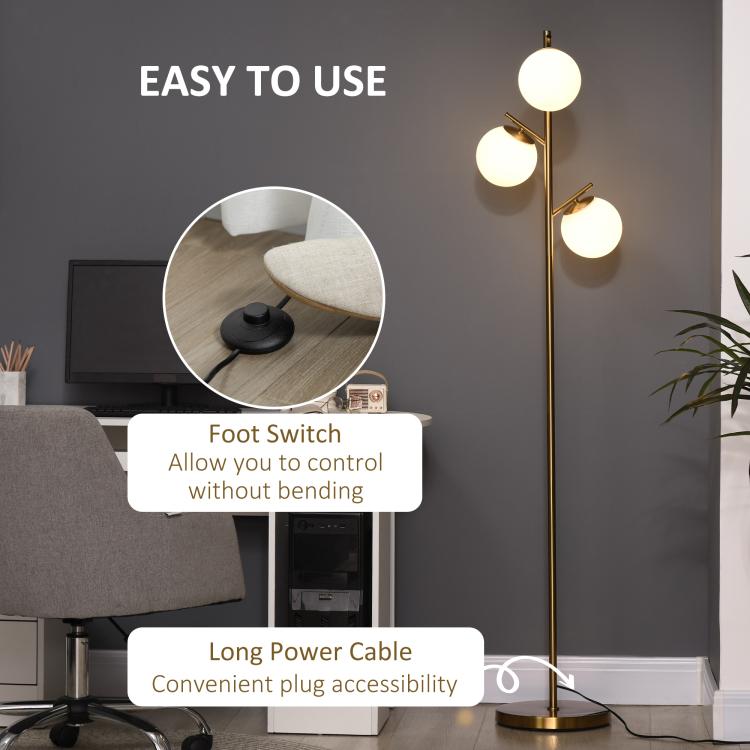 Gold floor lamp with foot switch control and three white globe shades