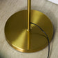 Round gold metal base with power cord for a standing floor lamp