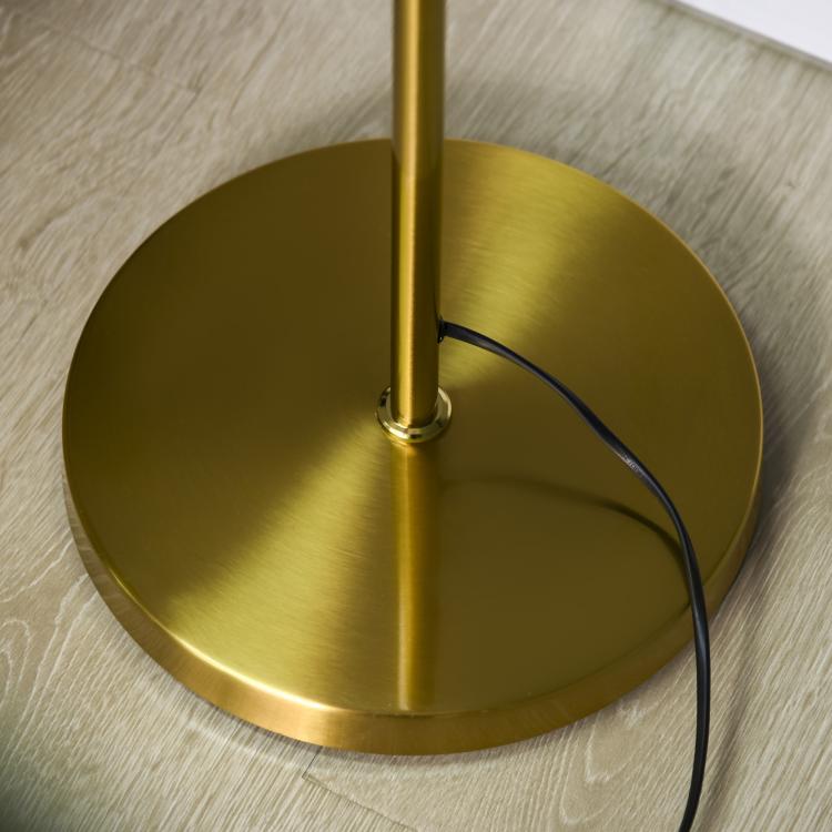 Round gold metal base with power cord for a standing floor lamp