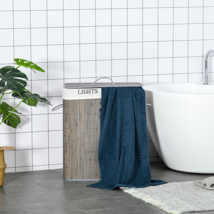 Gray bamboo laundry hamper with lid, holding a folded blue towel