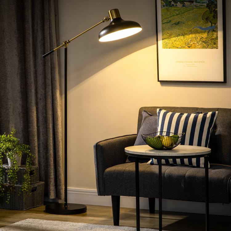 Black and gold standing floor lamp with adjustable arm and round light shade