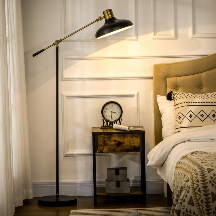 Black and gold adjustable floor lamp with balance arm and dome-style shade