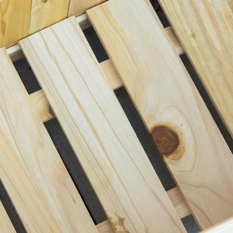 Close-up of slatted wood base panels inside a raised garden bed planter