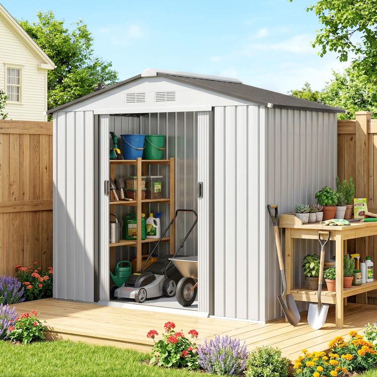 White outdoor storage shed with double sliding doors open, gardening tools inside