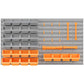 Wall mounted pegboard panel with gray and orange storage bins and hanging hooks