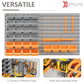 Wall pegboard organizer with gray bins, orange trays, and hooks on perforated rails