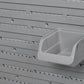 Close-up of gray pegboard holes with a mounted square storage bin