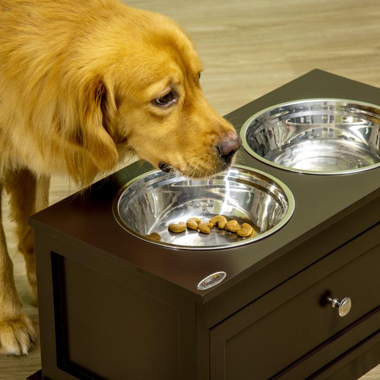 Brown raised dog bowl stand with two stainless steel bowls, dog eating