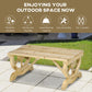 Natural wood outdoor bench on patio with wagon-wheel legs and slatted seat