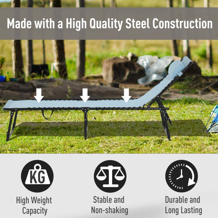 Light blue chaise lounge on grass with black steel legs and head pillow.