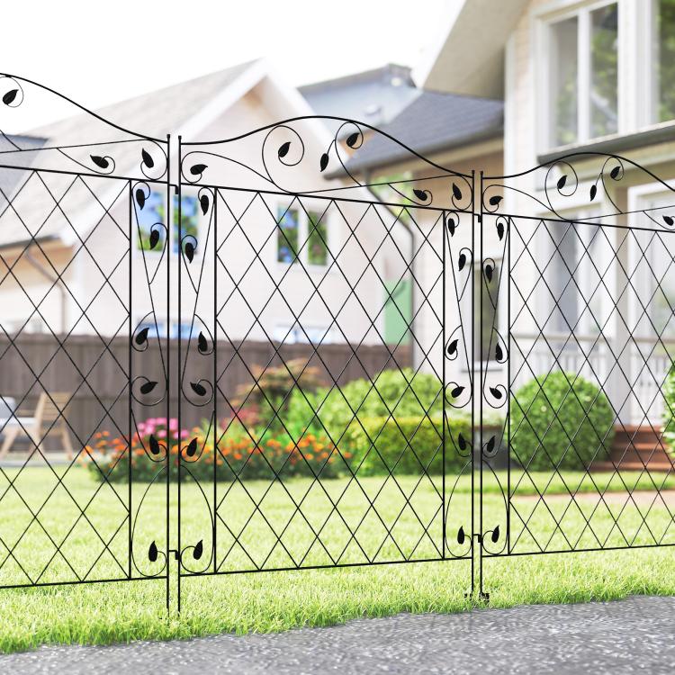 Black steel fence panel with diamond lattice and decorative scrollwork, set in yard