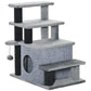Gray cat climbing stairs with three platforms, scratching posts, plush tunnel, and steps
