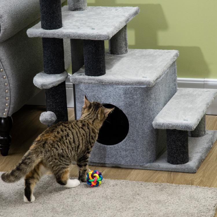 Gray cat stairs with carpet steps, scratching posts, and rope toy ball