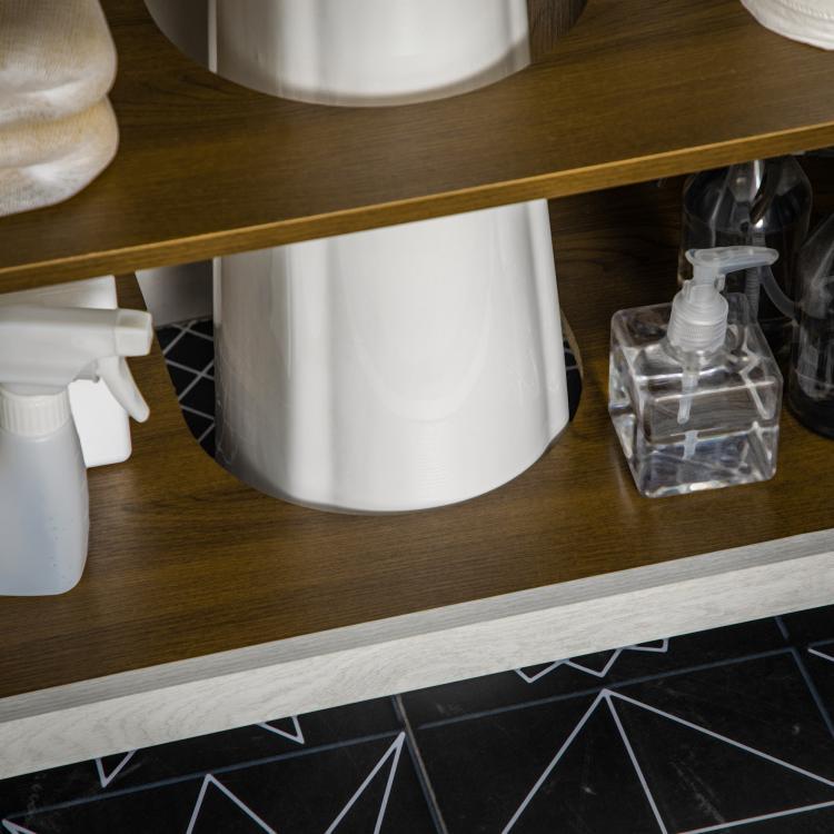 Lower shelf inside bathroom sink cabinet with cleaning bottles and pump dispenser